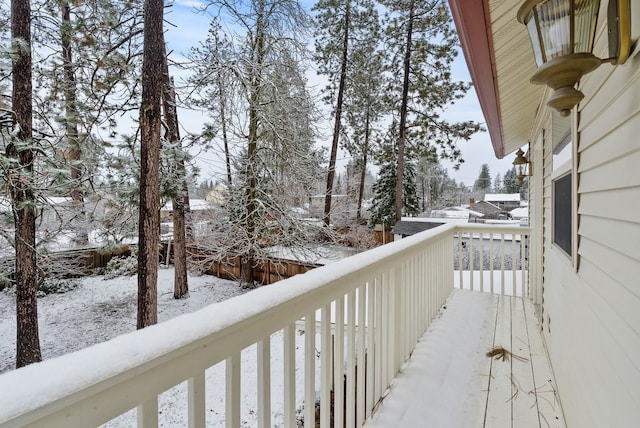 view of snow covered back of property