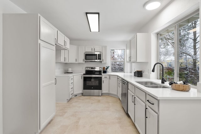 kitchen featuring white cabinetry, sink, plenty of natural light, and appliances with stainless steel finishes