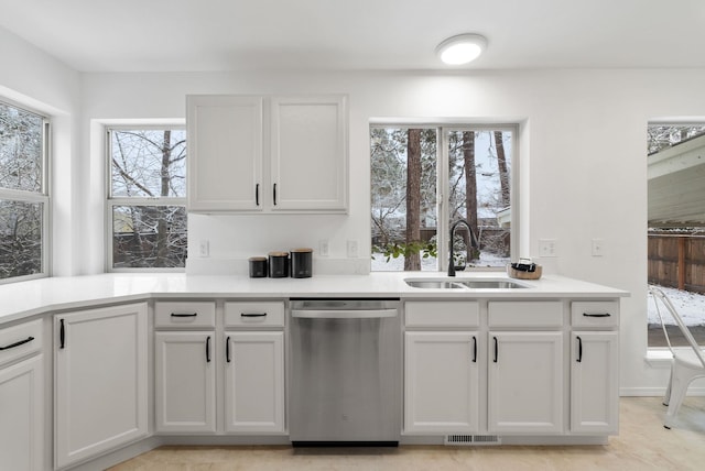 kitchen featuring dishwasher, white cabinets, and sink