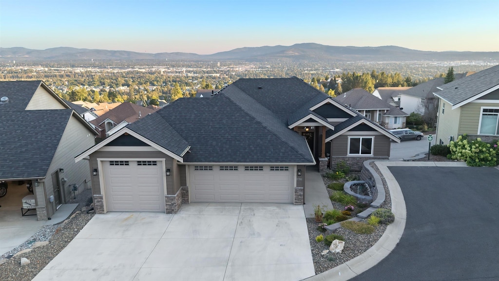 view of front facade with a mountain view and a garage