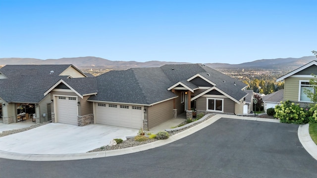 view of front of property featuring a mountain view and a garage