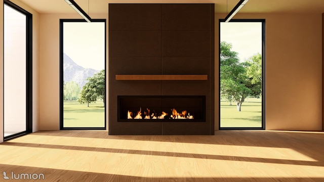 doorway to outside featuring a mountain view and a tiled fireplace