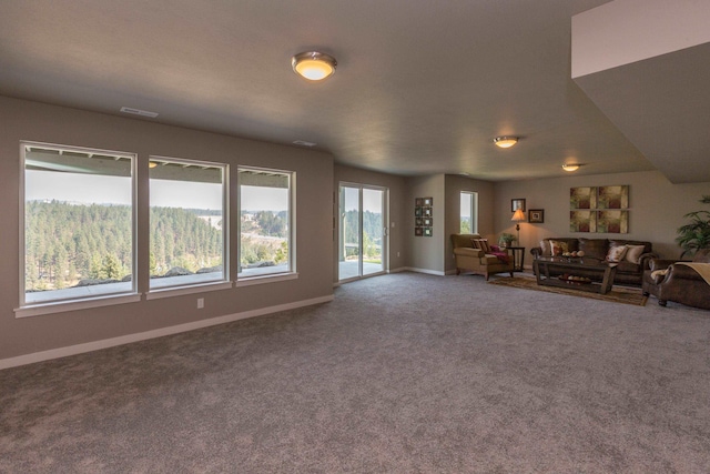 unfurnished living room with visible vents, baseboards, and carpet flooring