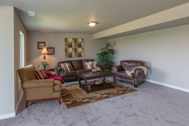 living room with carpet floors, visible vents, and baseboards