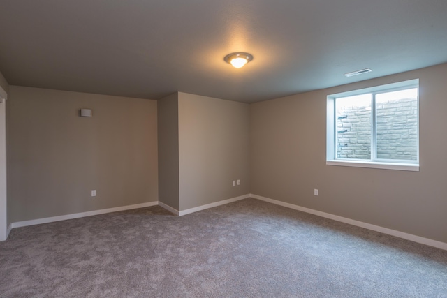 carpeted empty room with visible vents and baseboards