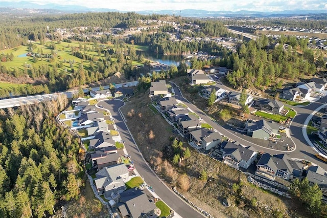 bird's eye view with a residential view, a water view, and a wooded view