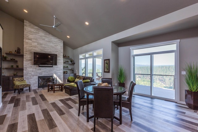 dining room featuring plenty of natural light, a fireplace, and wood finished floors