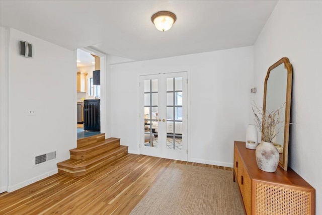 entryway with hardwood / wood-style flooring and french doors