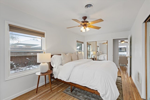 bedroom with ceiling fan and light hardwood / wood-style flooring