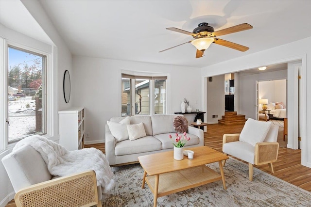 living room featuring wood-type flooring and ceiling fan