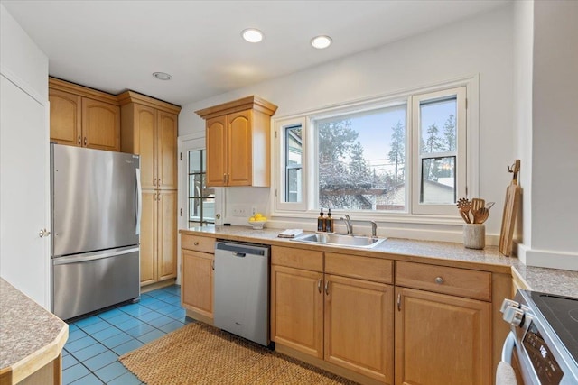 kitchen featuring a wealth of natural light, sink, light tile patterned floors, and appliances with stainless steel finishes