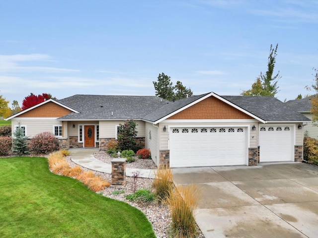 view of front of house featuring a front yard and a garage