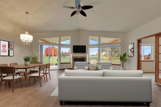 living room featuring hardwood / wood-style floors and ceiling fan with notable chandelier