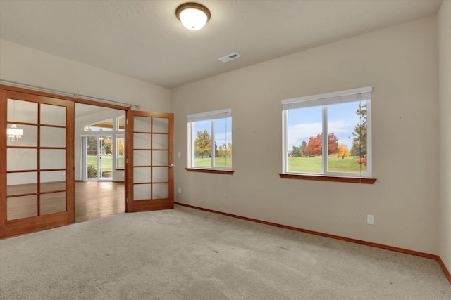 empty room featuring carpet flooring and french doors