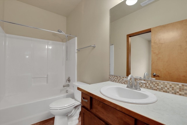 full bathroom featuring backsplash, toilet, vanity, and washtub / shower combination