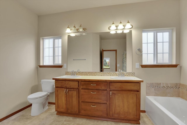 bathroom with a washtub, toilet, and vanity