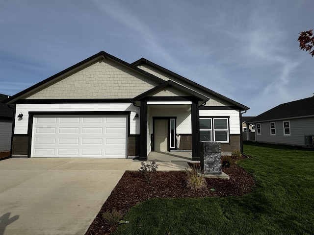 view of front of home featuring central AC, a front lawn, covered porch, and a garage