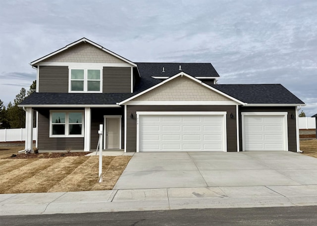 view of front of house featuring a garage, driveway, and a shingled roof