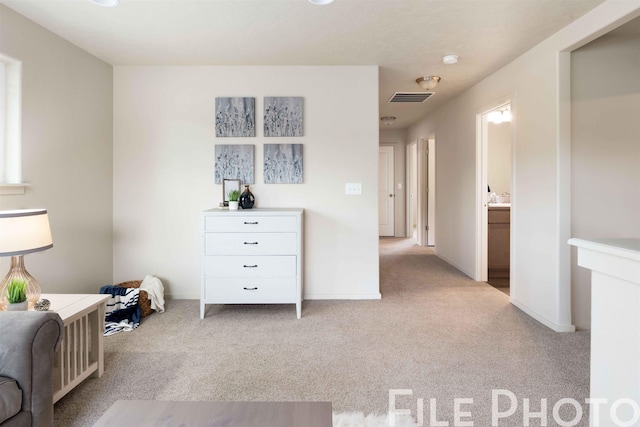 unfurnished bedroom featuring connected bathroom and light colored carpet