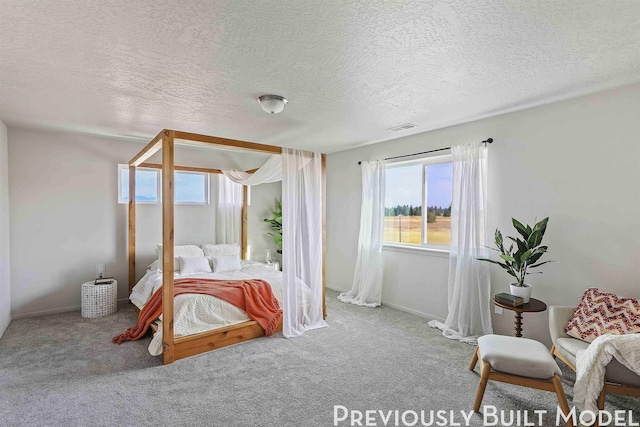 carpeted bedroom with a textured ceiling