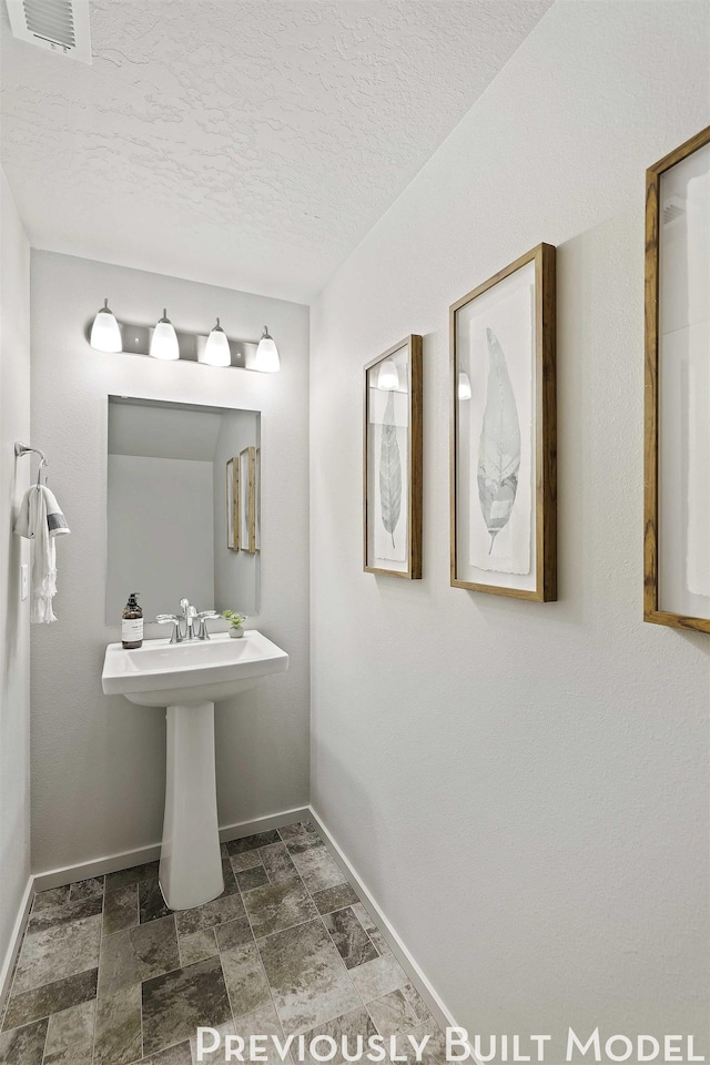 bathroom with a textured ceiling