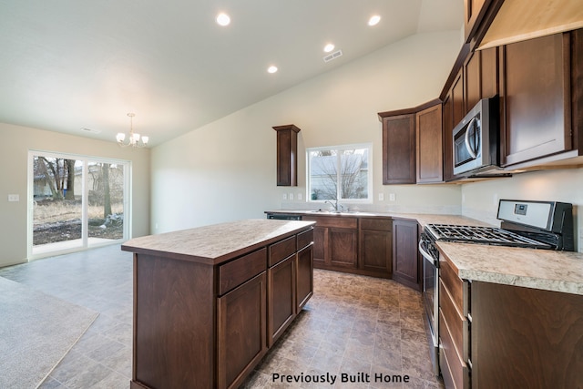 kitchen with a notable chandelier, plenty of natural light, lofted ceiling, and appliances with stainless steel finishes