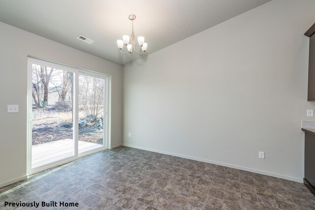 unfurnished dining area featuring a chandelier