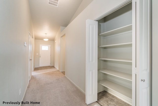 hallway featuring light colored carpet