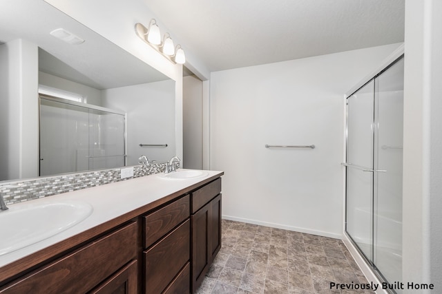 bathroom with vanity and a shower with door