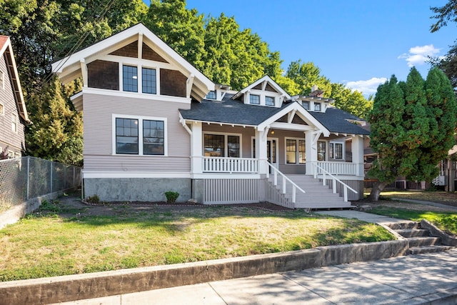 view of front facade with covered porch and a front yard