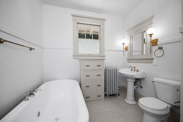 bathroom featuring a bath, radiator heating unit, tile patterned floors, and toilet