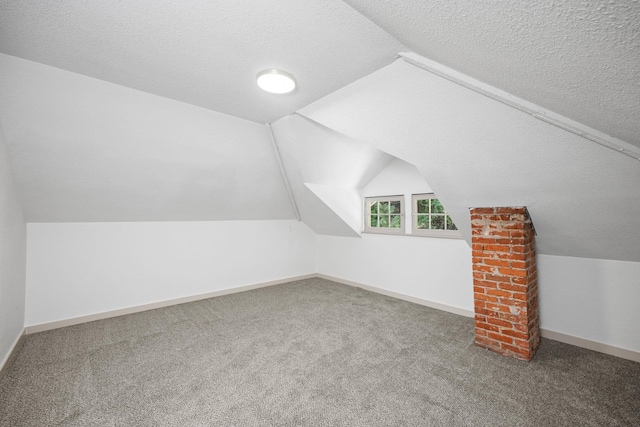 bonus room with carpet flooring, a textured ceiling, and vaulted ceiling