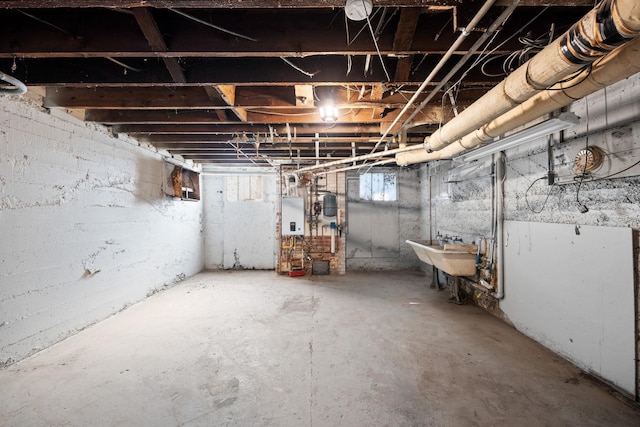 basement with tankless water heater and sink