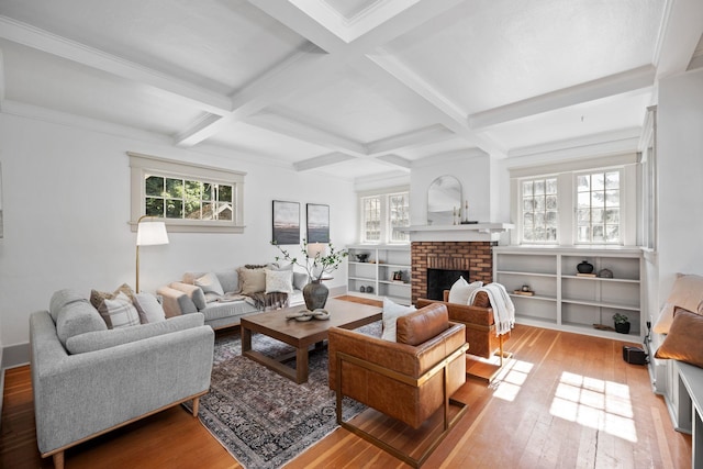 living room featuring beam ceiling, wood-type flooring, a fireplace, and coffered ceiling