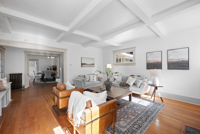 living room with beam ceiling, radiator, and coffered ceiling