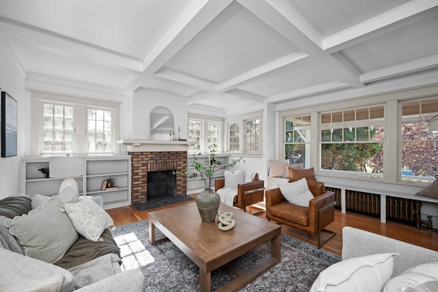 living room with a fireplace, beamed ceiling, wood-type flooring, and coffered ceiling