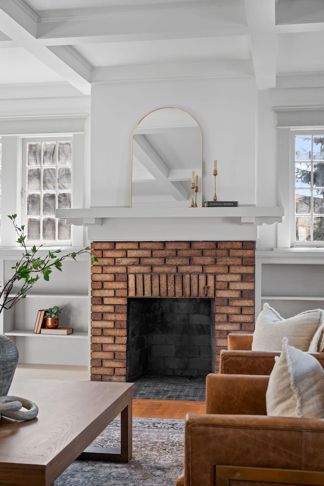 living room with a brick fireplace, beam ceiling, and coffered ceiling