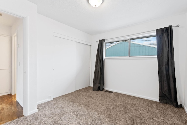 unfurnished bedroom with carpet floors and a closet