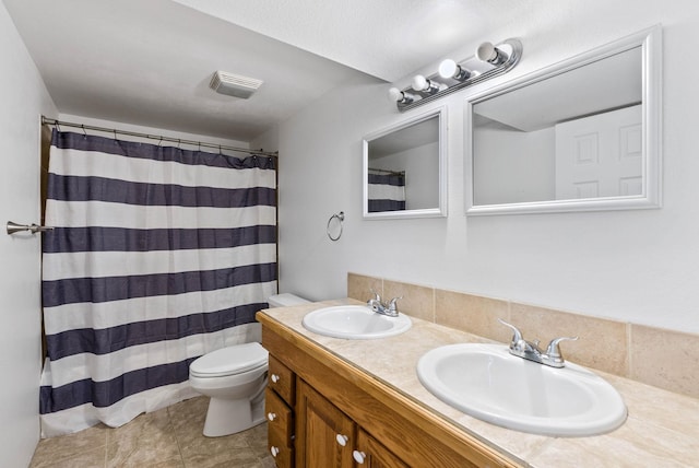 bathroom featuring vanity, toilet, and walk in shower