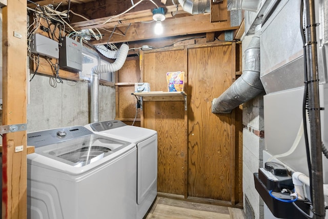 clothes washing area with washing machine and clothes dryer and heating unit