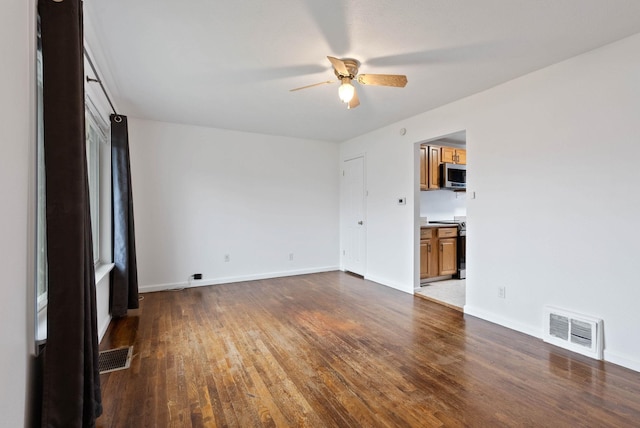 unfurnished room featuring ceiling fan and dark hardwood / wood-style floors