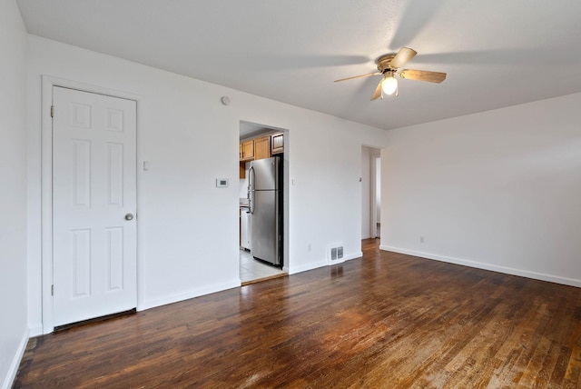 unfurnished bedroom with stainless steel fridge, ceiling fan, and wood-type flooring