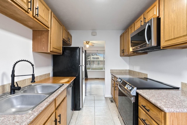 kitchen with ceiling fan, light tile patterned floors, sink, and appliances with stainless steel finishes