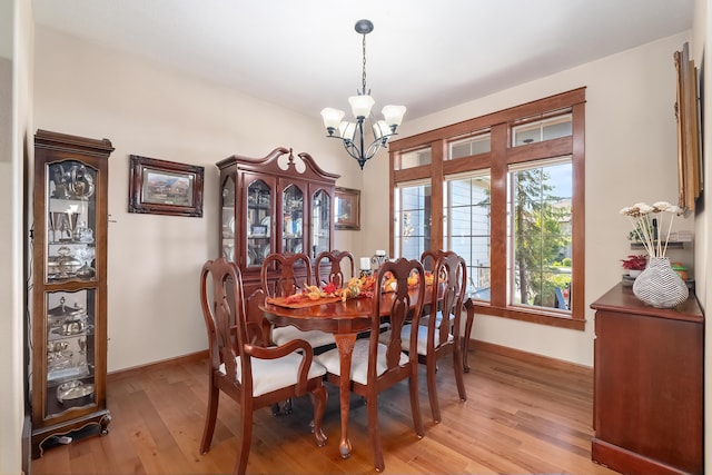 dining area with a chandelier and light hardwood / wood-style floors