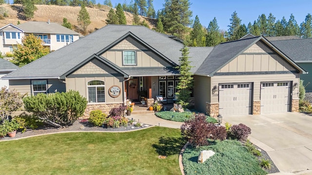 craftsman-style house with a garage and a front yard