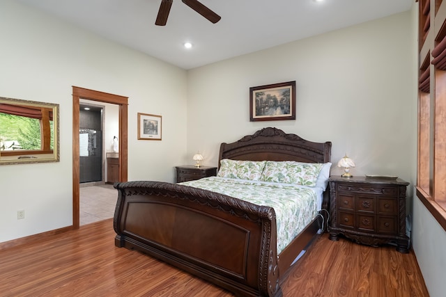 bedroom with connected bathroom, light hardwood / wood-style floors, and ceiling fan