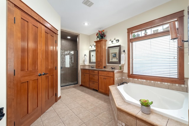 bathroom featuring tile patterned floors, vanity, and independent shower and bath