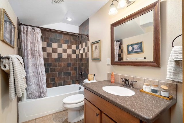 full bathroom featuring tile patterned floors, vanity, toilet, and shower / tub combo with curtain