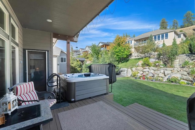 wooden terrace with a yard and a hot tub