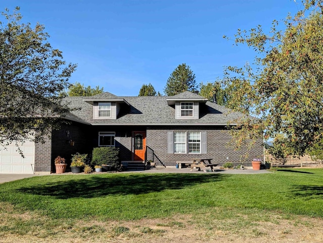 view of front of house with a garage and a front yard